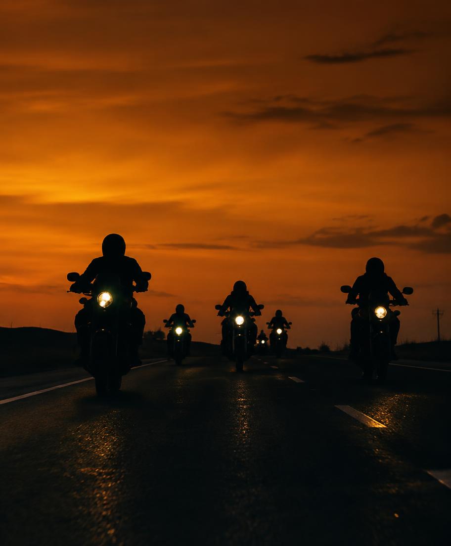 Riders silhouetted against an amber dusk sky