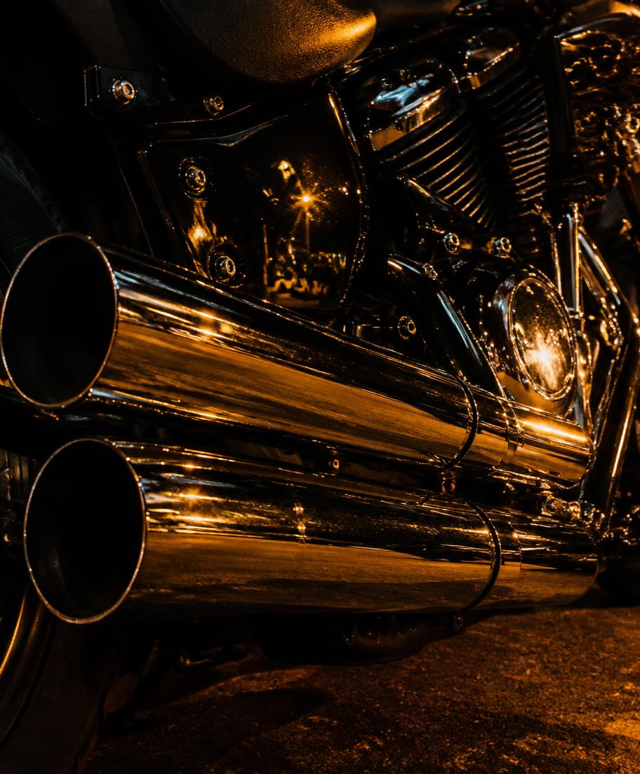 Chrome pipes glowing under amber streetlight